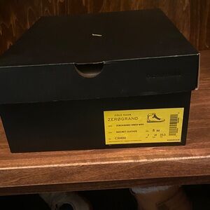 New with tags and original box. Cole Haan Zerogrand Black boots with red laces
